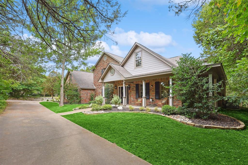 a front view of a house with garden and porch