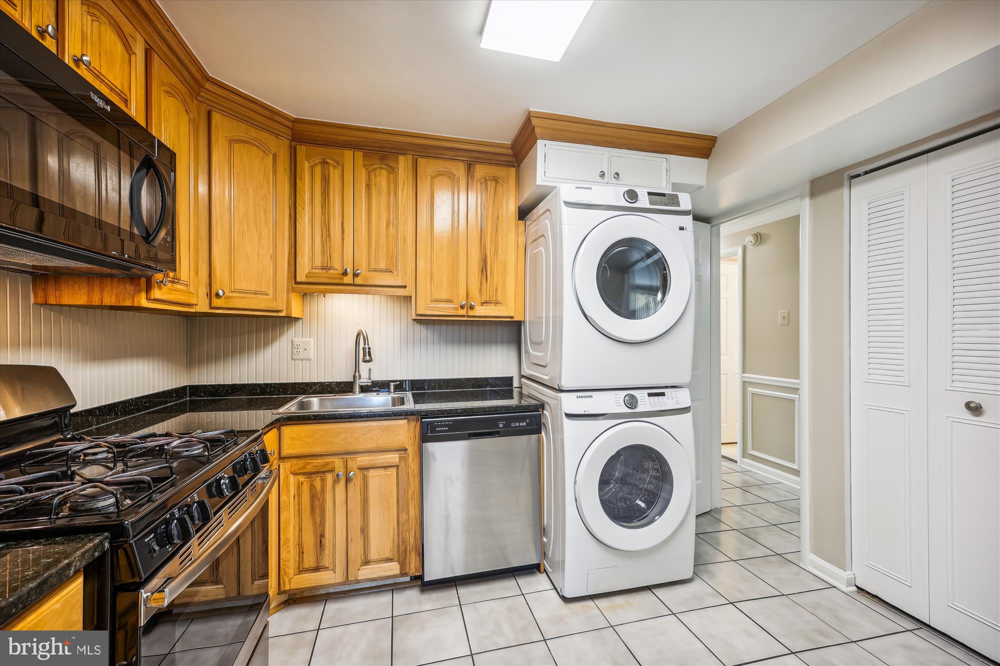 a utility room with sink dryer and washer