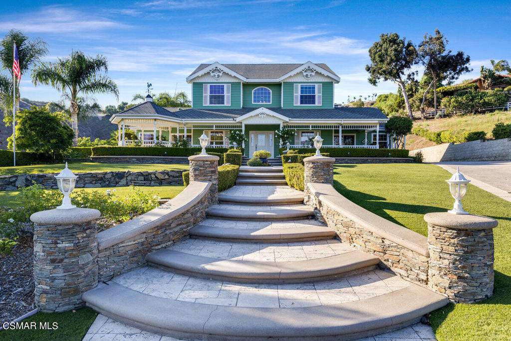 a front view of a house with swimming pool having outdoor seating