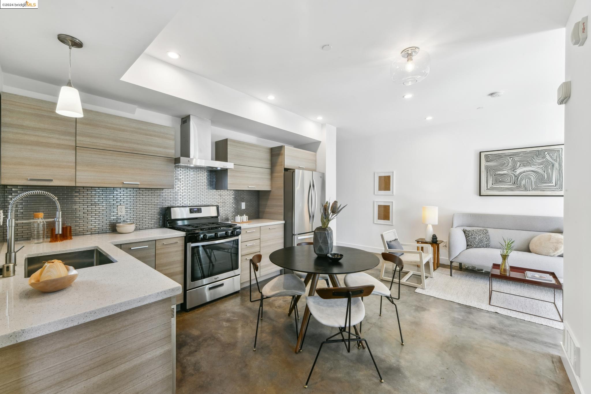 a kitchen with a sink appliances and cabinets