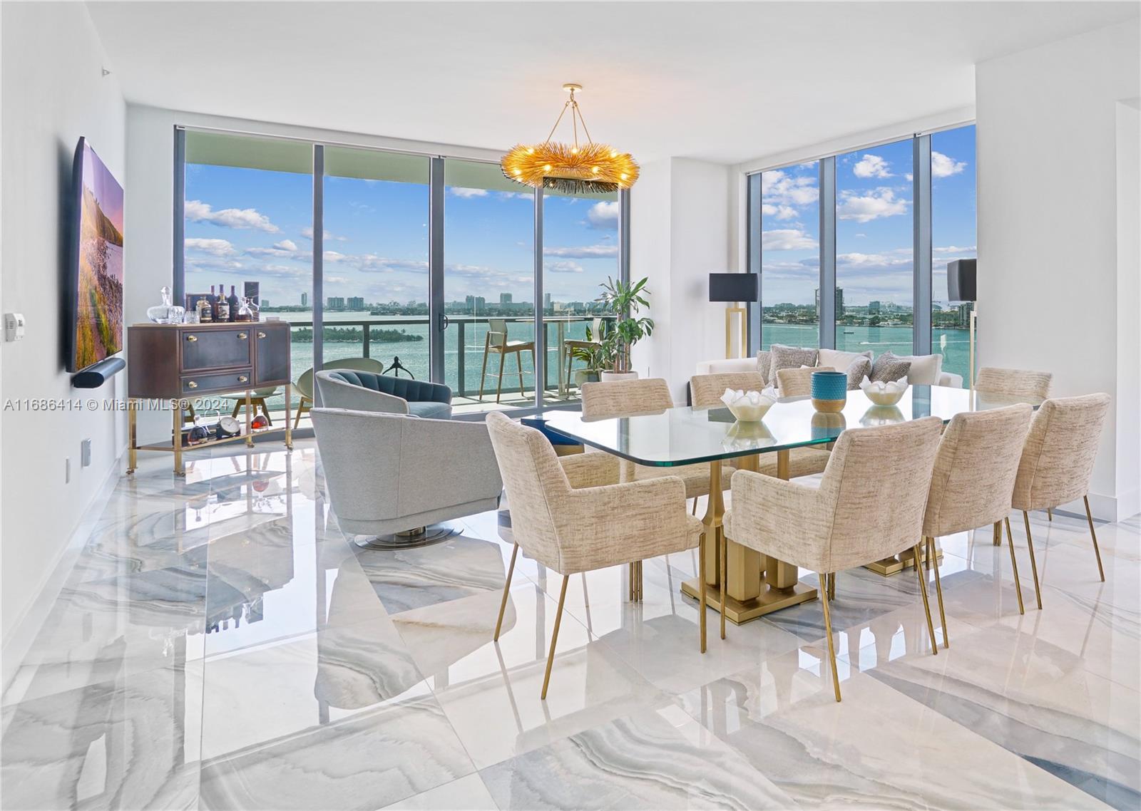 a dining room with furniture water view and a floor to ceiling window