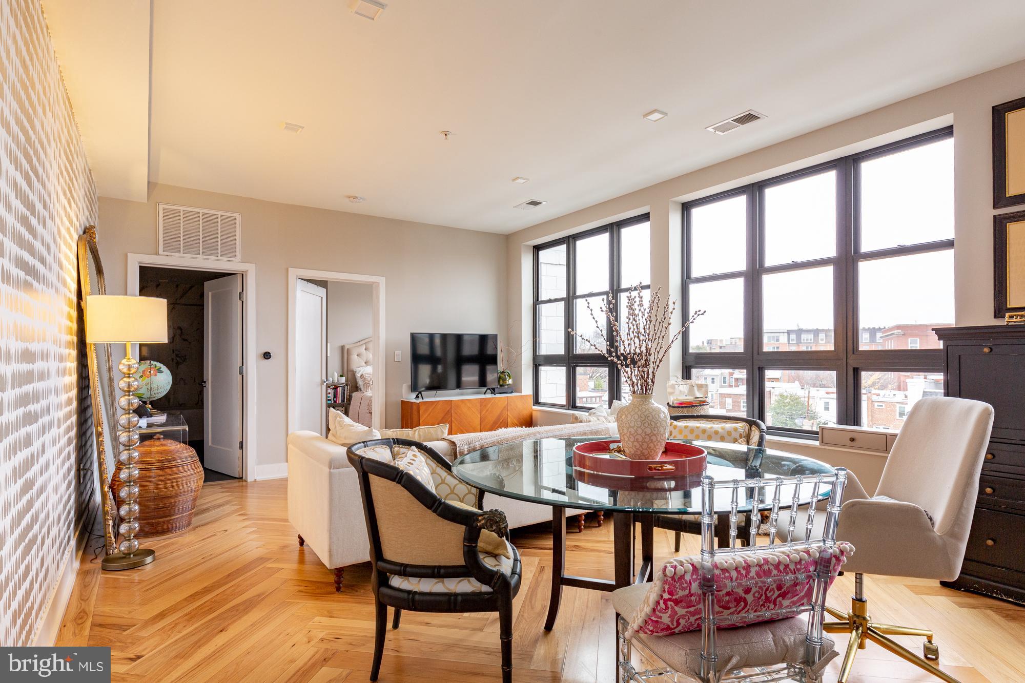 a dining room with furniture and wooden floor