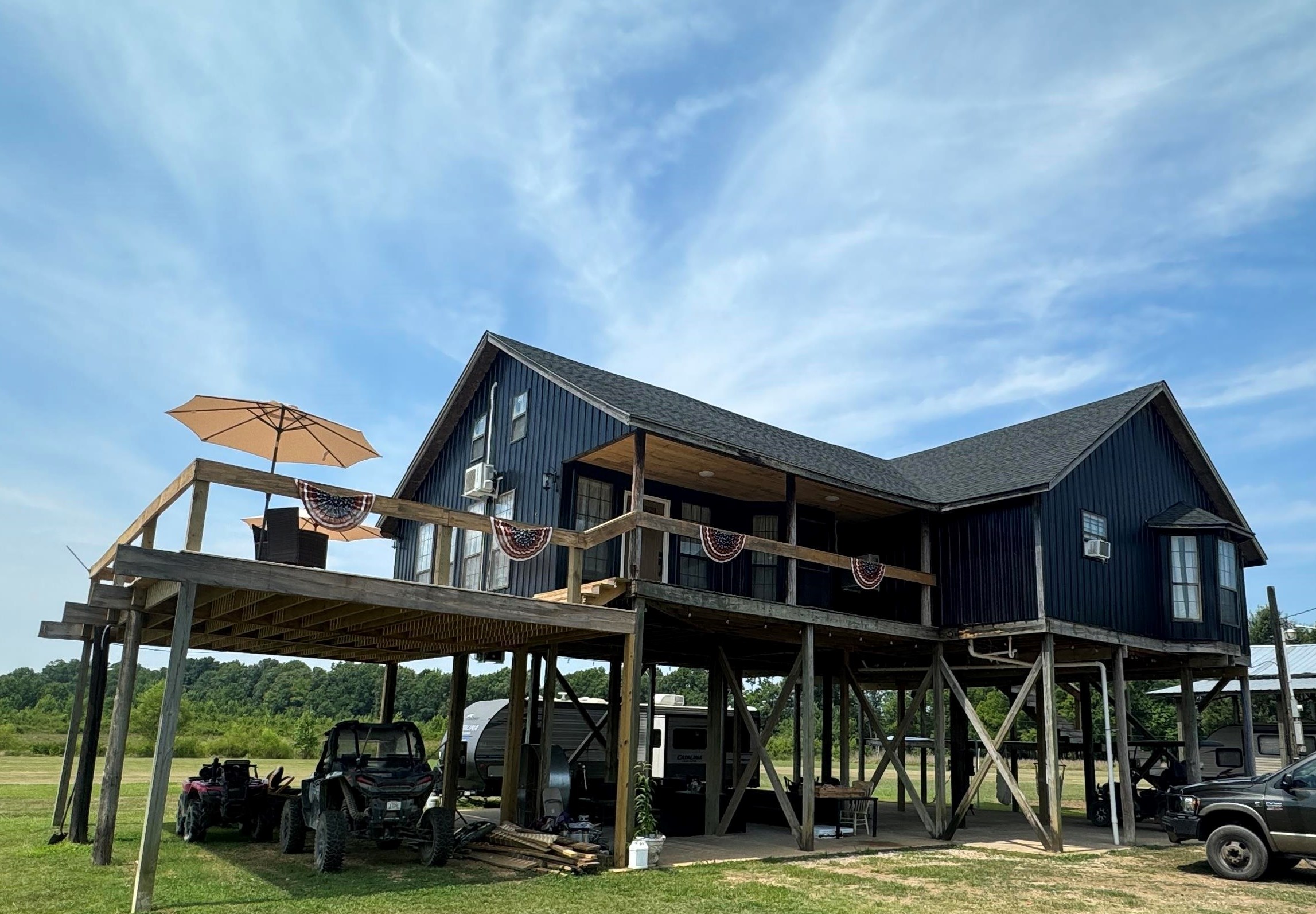 a backyard of a house with barbeque oven table and chairs