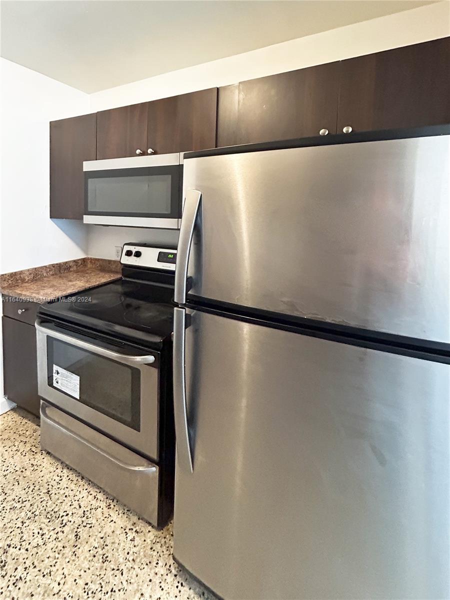 a close view of a stove top oven and refrigerator