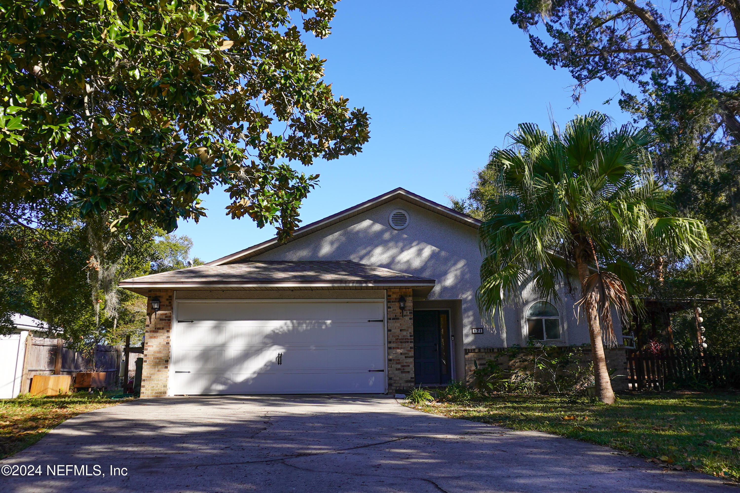 a view of a house with a tree and a yard