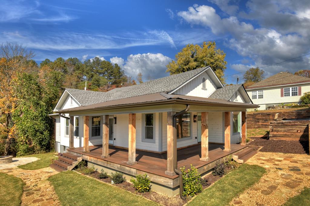 a view of a house with a yard and balcony