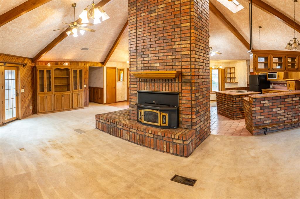 a view of a livingroom with fireplace and furniture