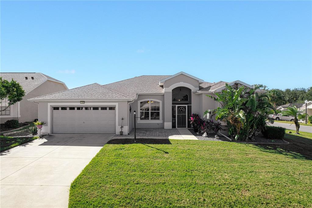 a front view of a house with a yard and garage