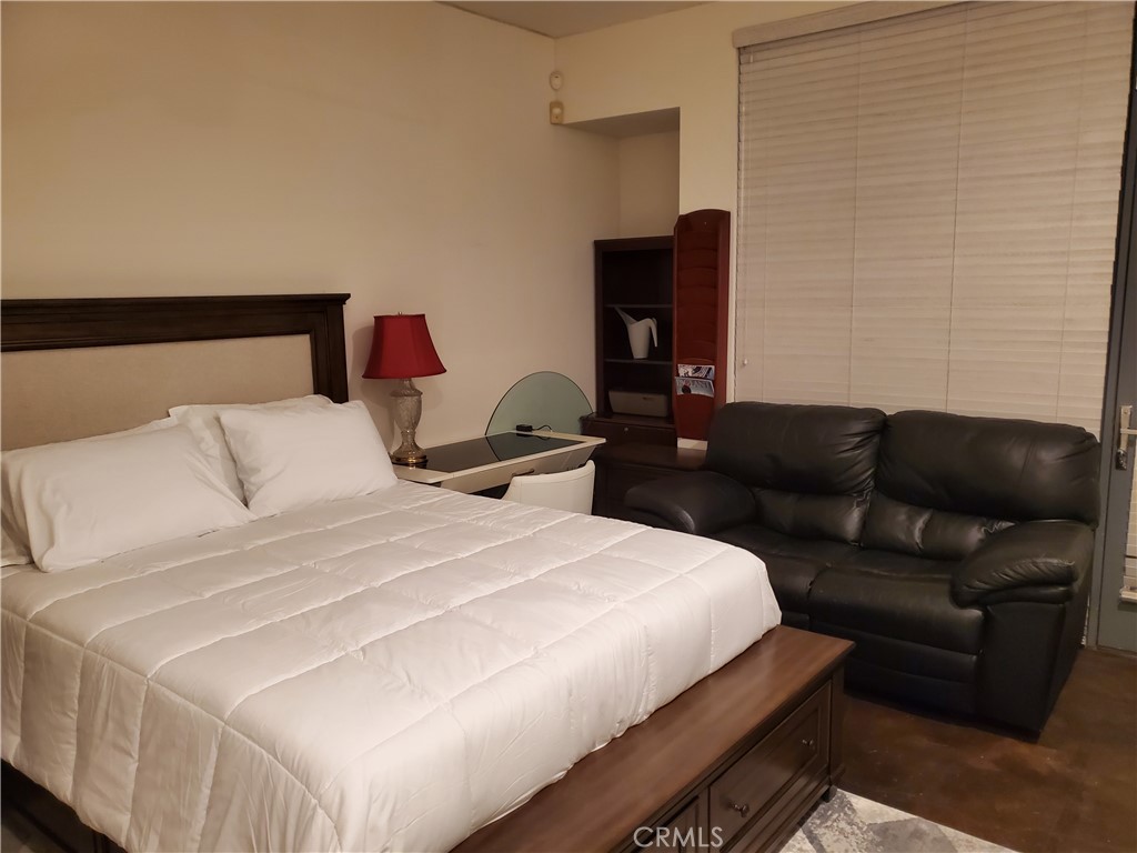 a bedroom with a bed and a couch