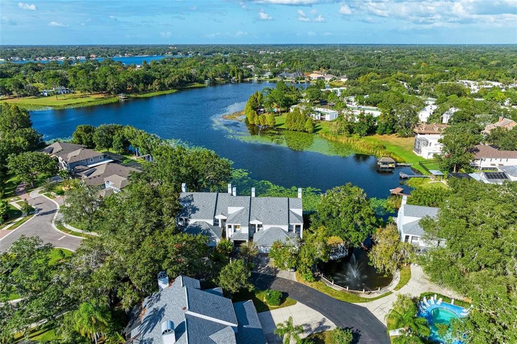 an aerial view of residential houses with outdoor space and swimming pool