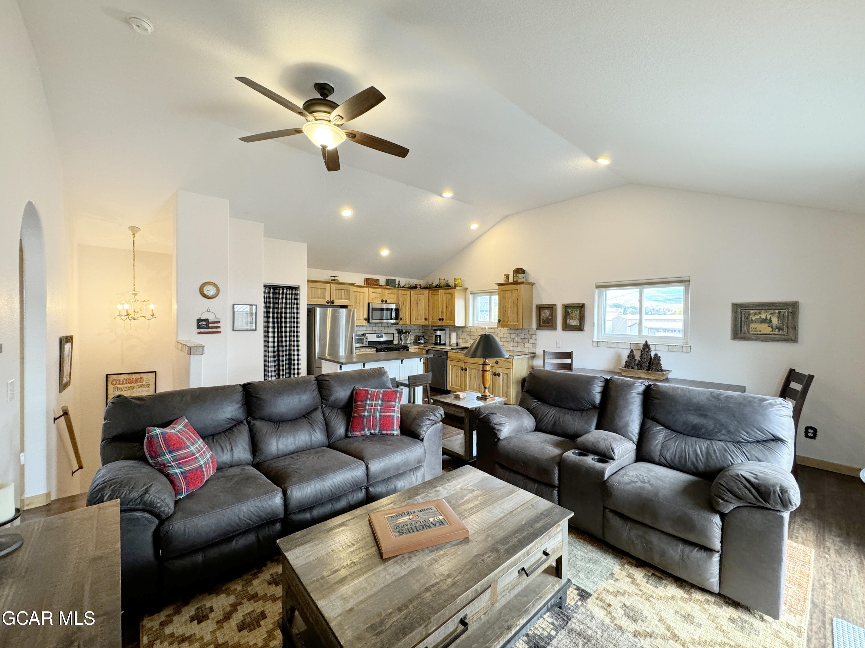 a living room with furniture and a ceiling fan