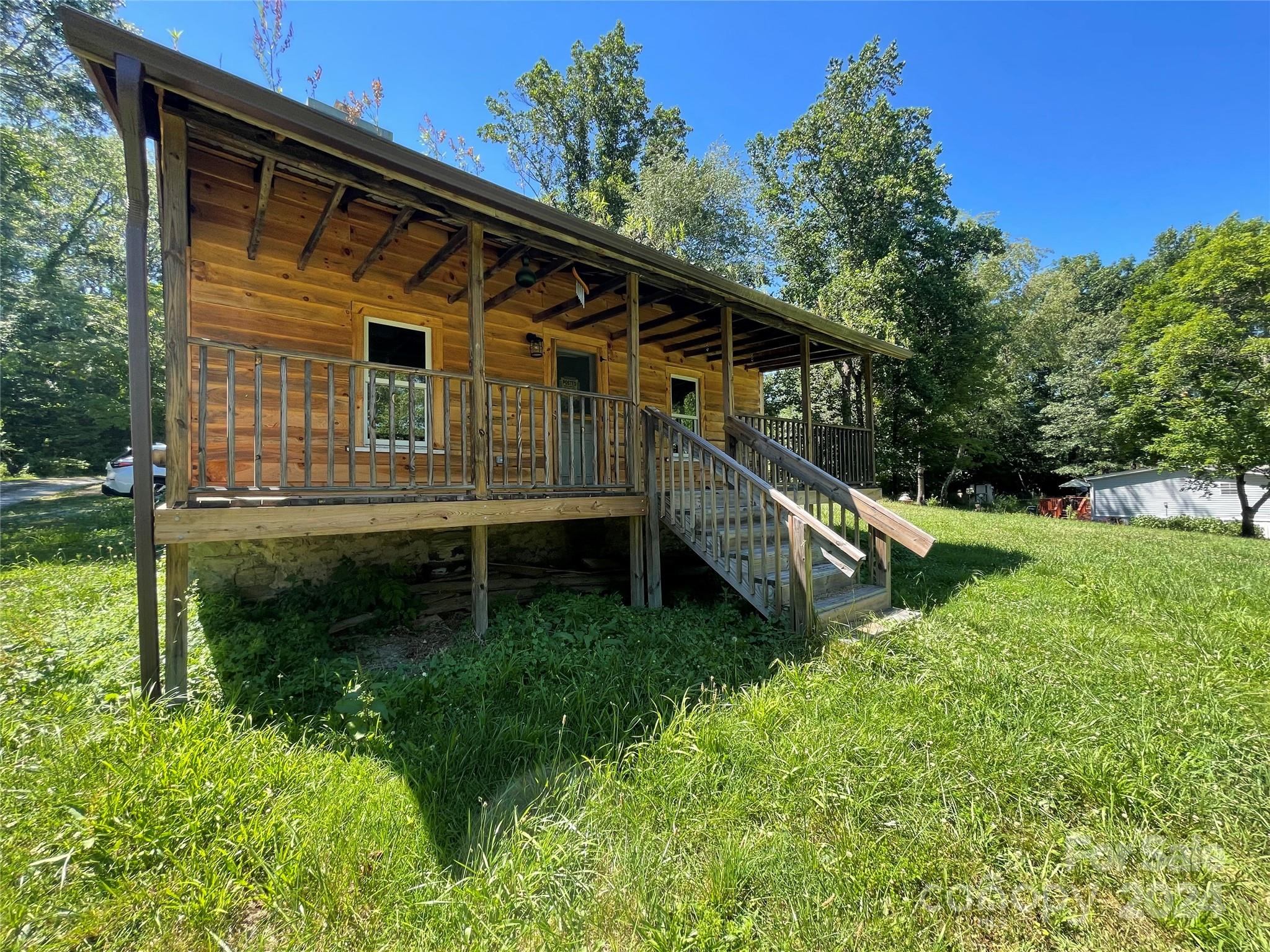 a backyard of a house with wooden floor and fence