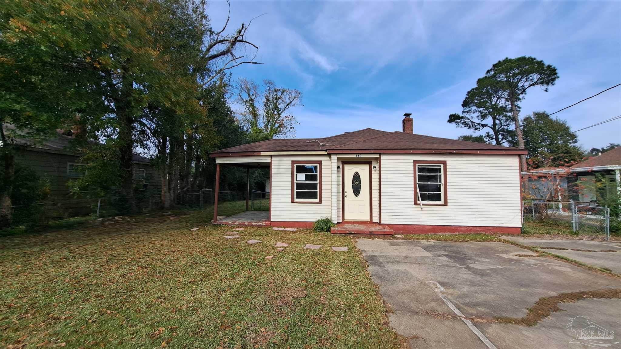 a front view of a house with a garden