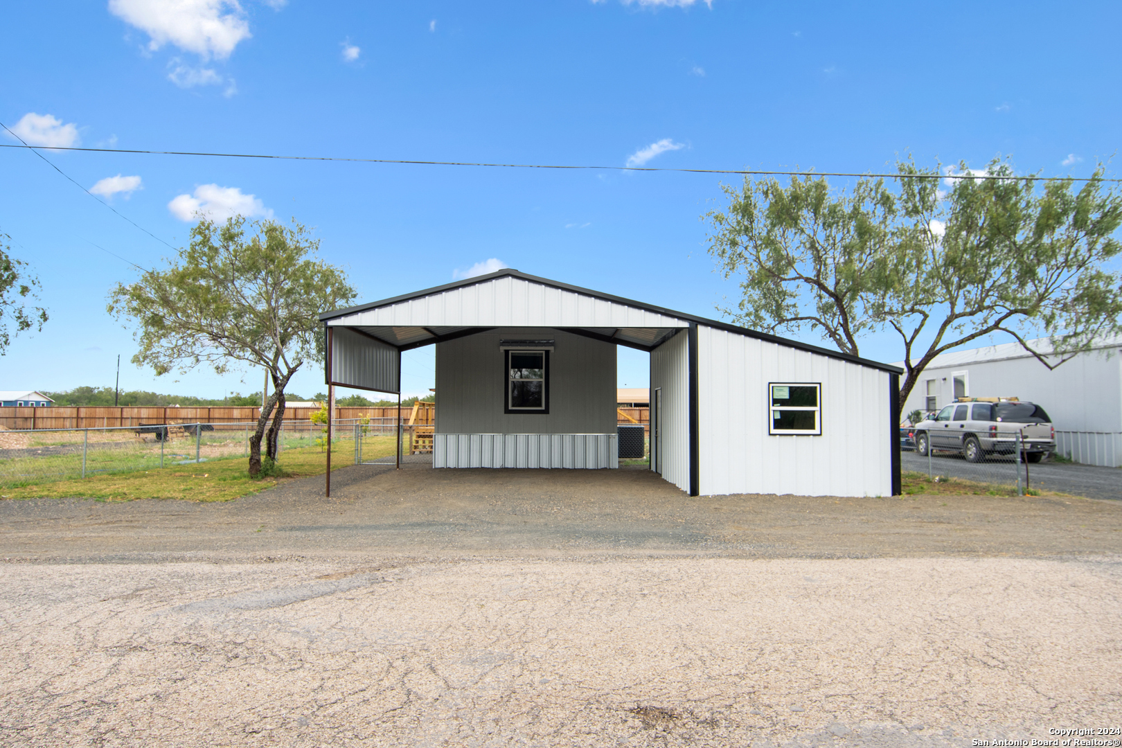 a view of a house with a yard and garage