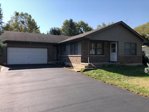 a backyard of a house with yard and garage