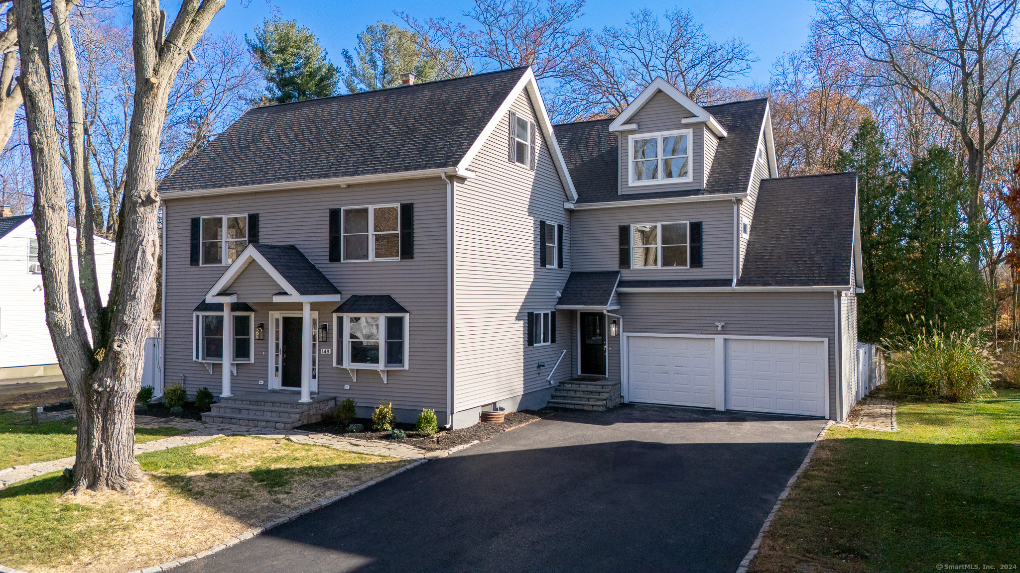 a front view of a house with a yard and garage