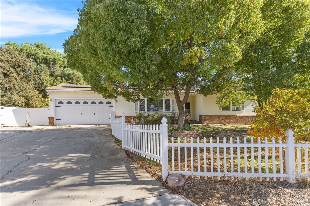 a view of a house with a small yard and wooden fence