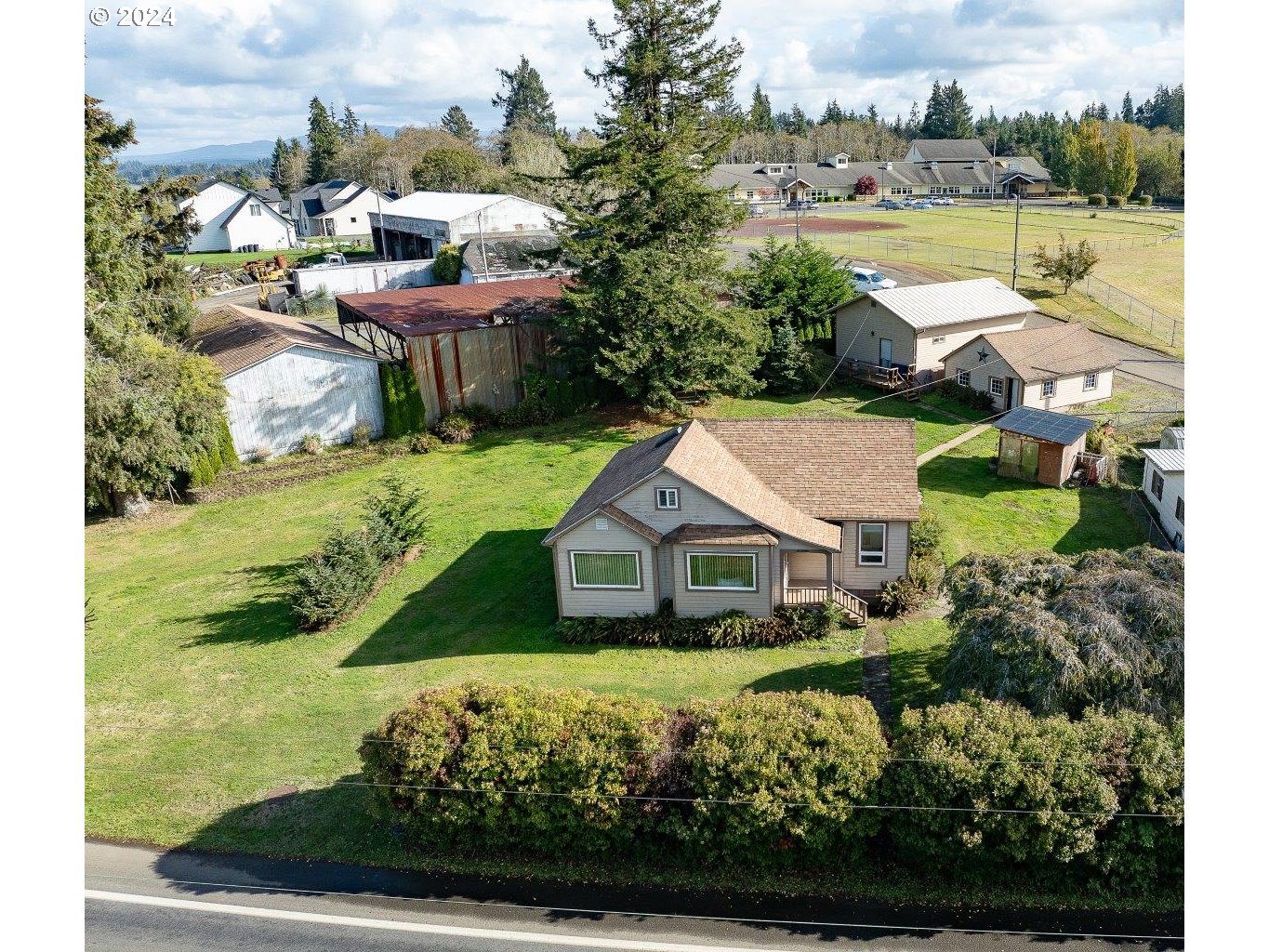 a aerial view of a house with a yard basket ball court and outdoor seating