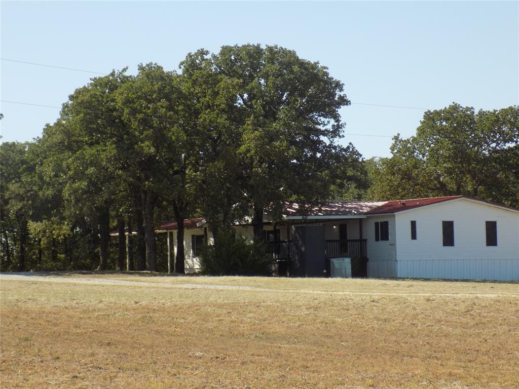 a backyard of a house with large trees