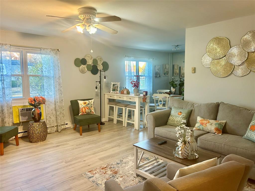 a living room with furniture chandelier and a fireplace