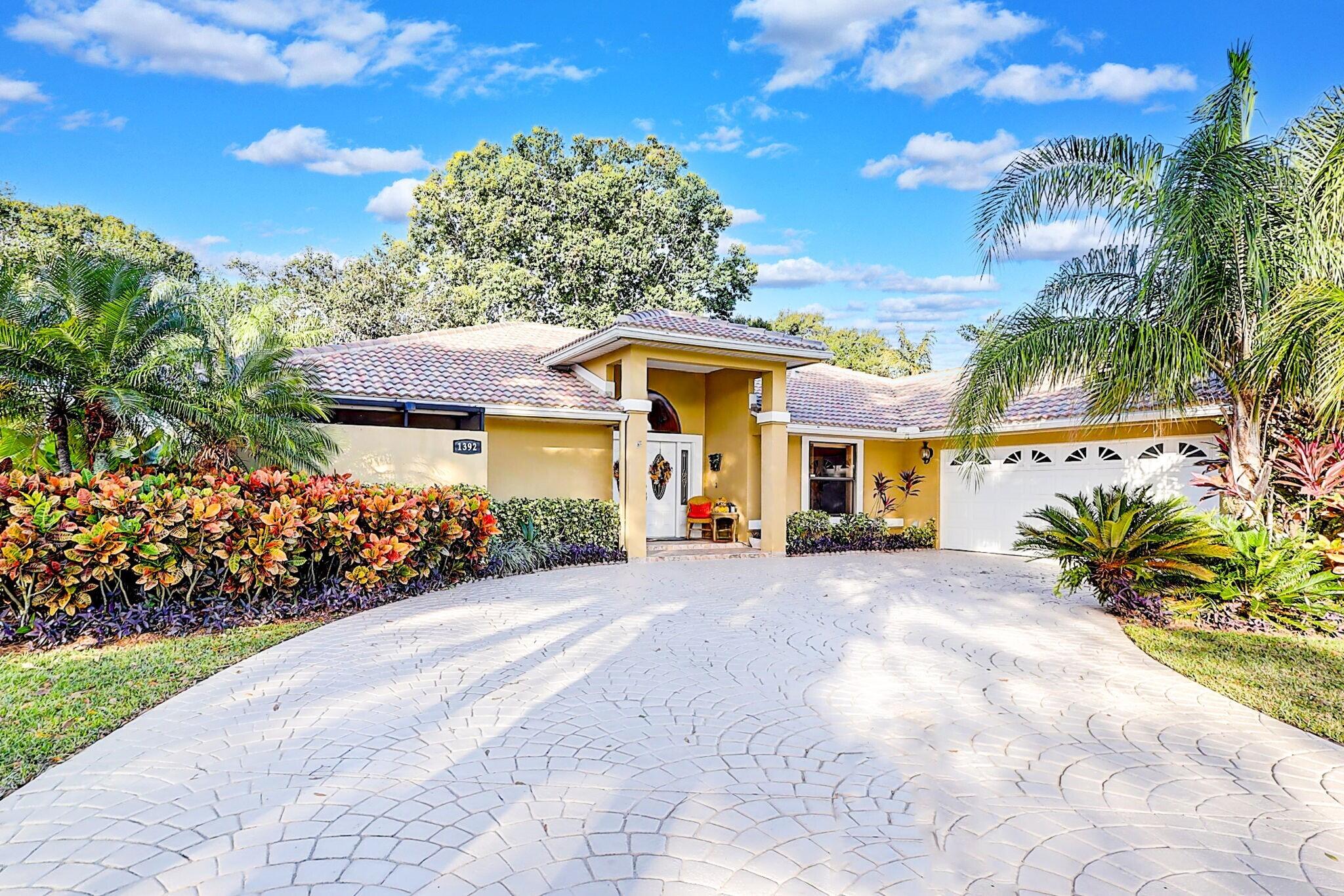 a front view of a house with a yard and a garage