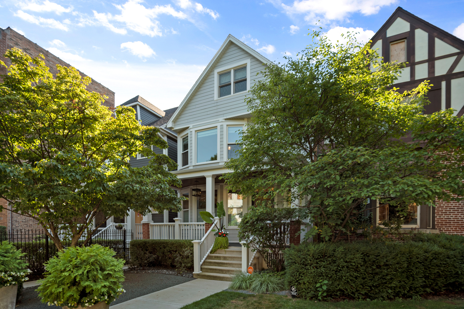 a front view of a house with a yard and green space