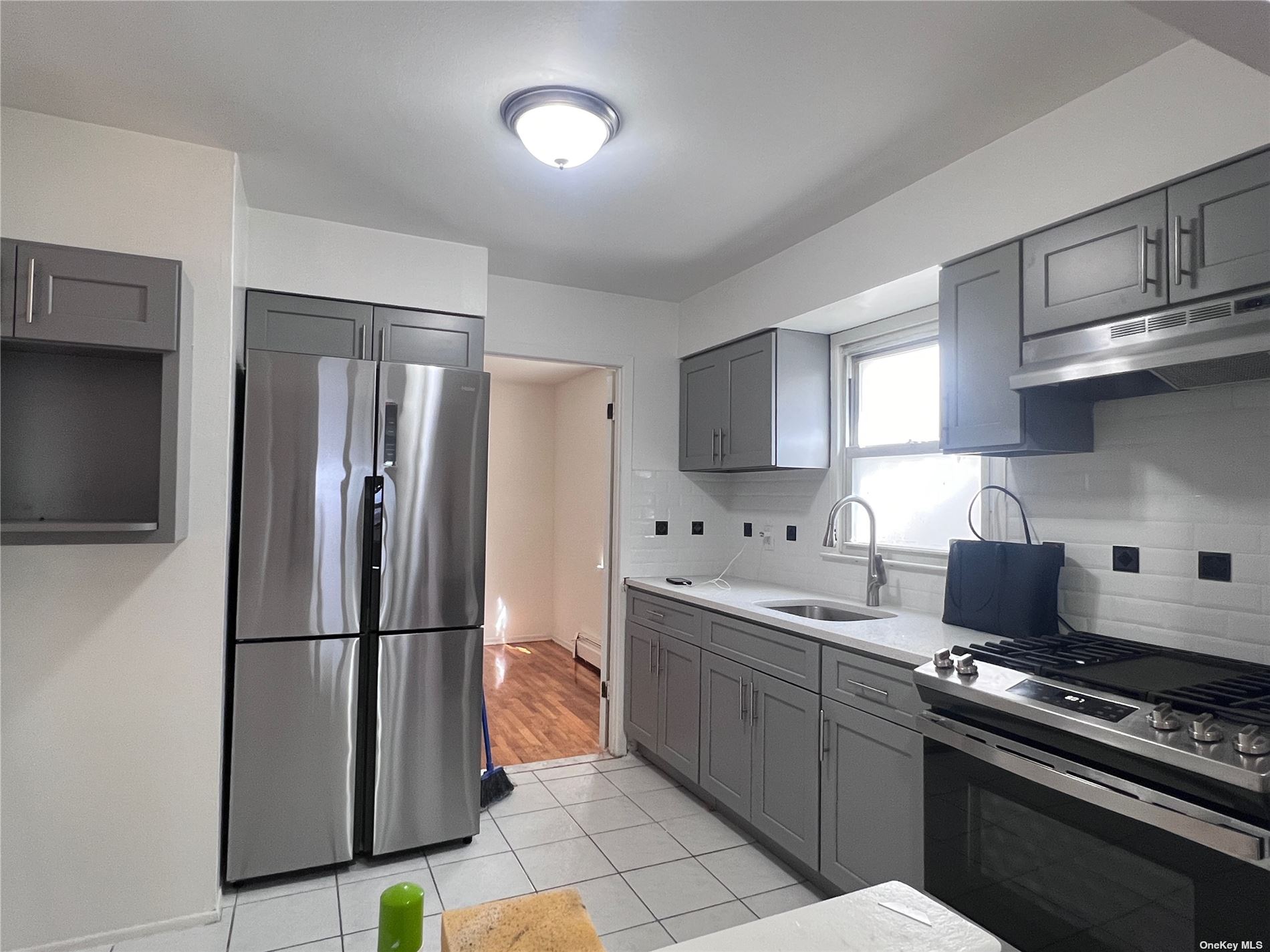 a kitchen with stainless steel appliances a refrigerator sink and stove