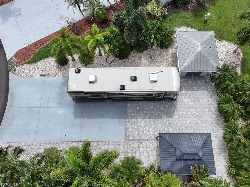 a aerial view of a house with plants and a bench