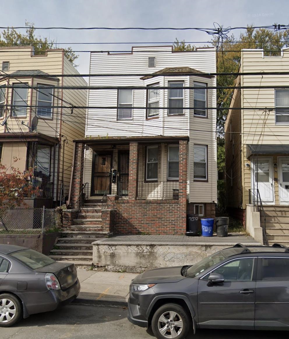 a front view of a house with parking space