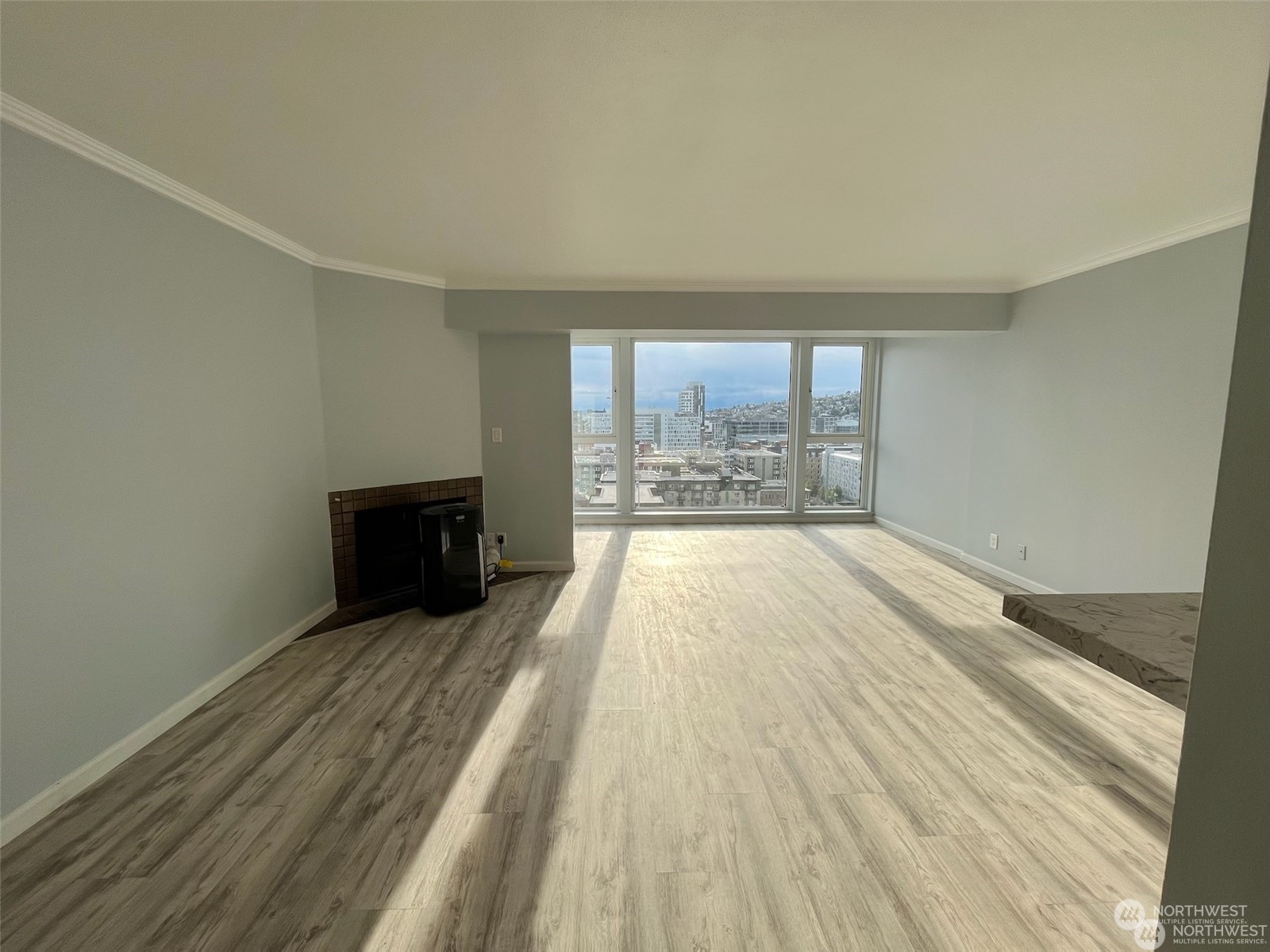 wooden floor in an empty room with a fireplace