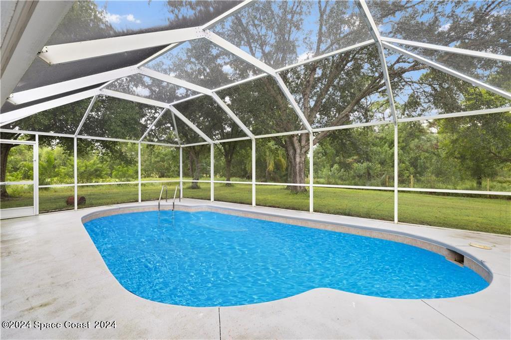 a view of a backyard with a swimming pool