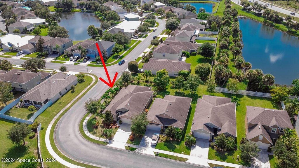 an aerial view of residential house with outdoor space and swimming pool