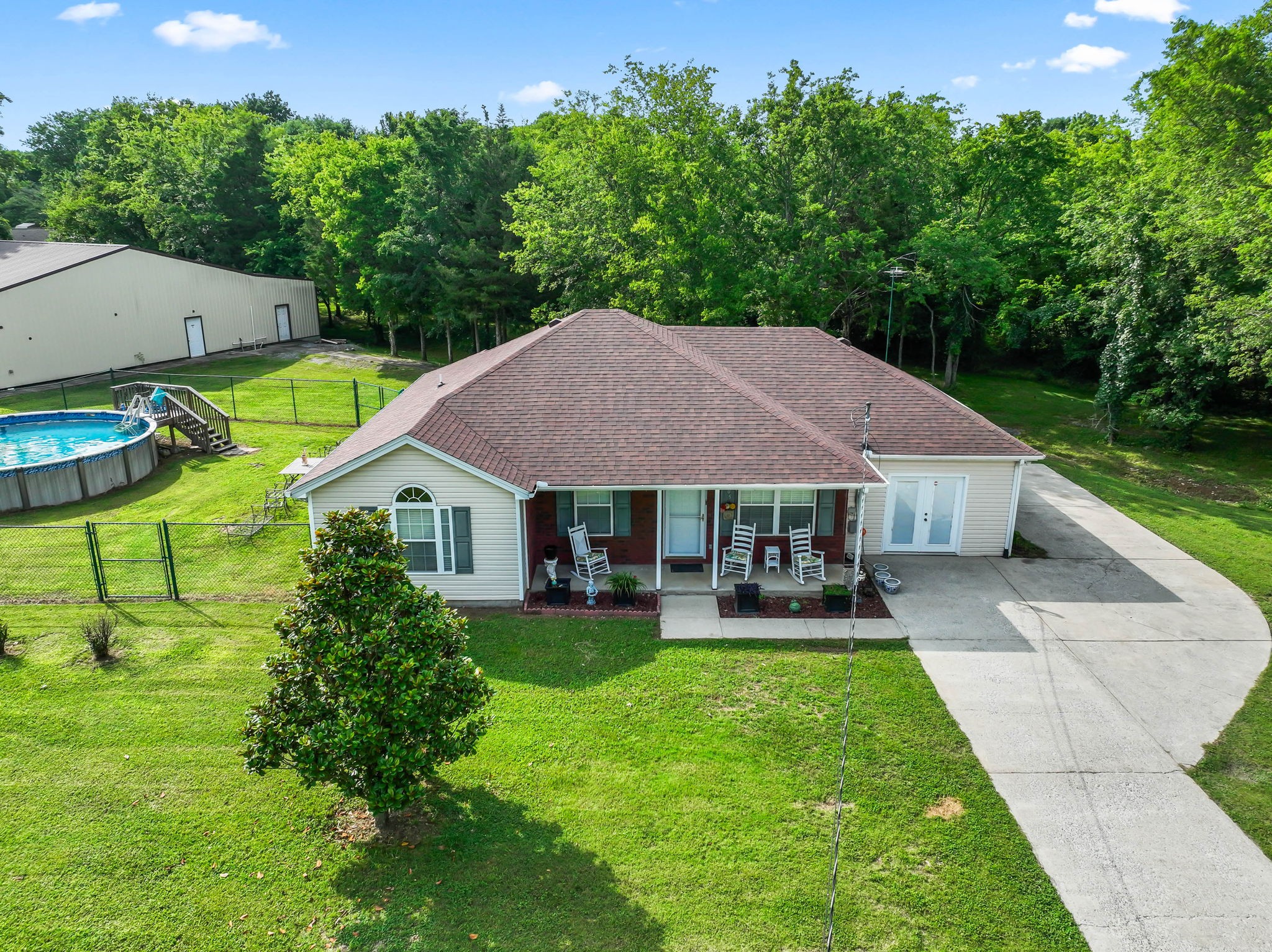 a aerial view of a house with swimming pool next to a yard