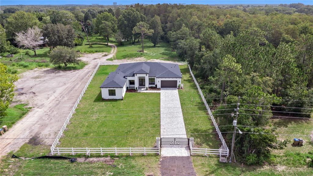 an aerial view of a house with a yard