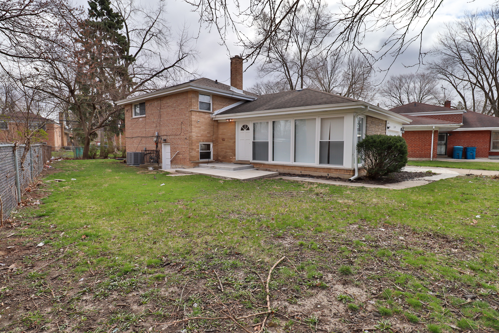 a front view of a house with a garden and trees