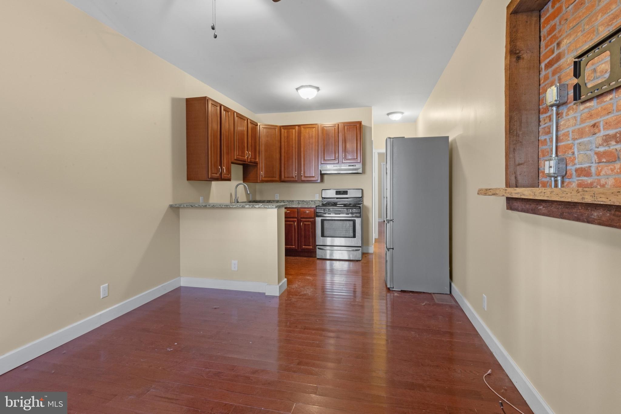 a view of kitchen with wooden floor