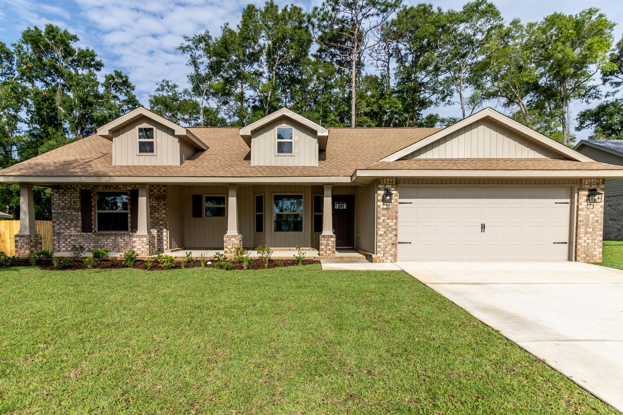 a front view of a house with a yard and porch