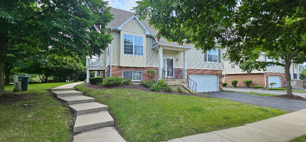 a front view of house with yard and green space