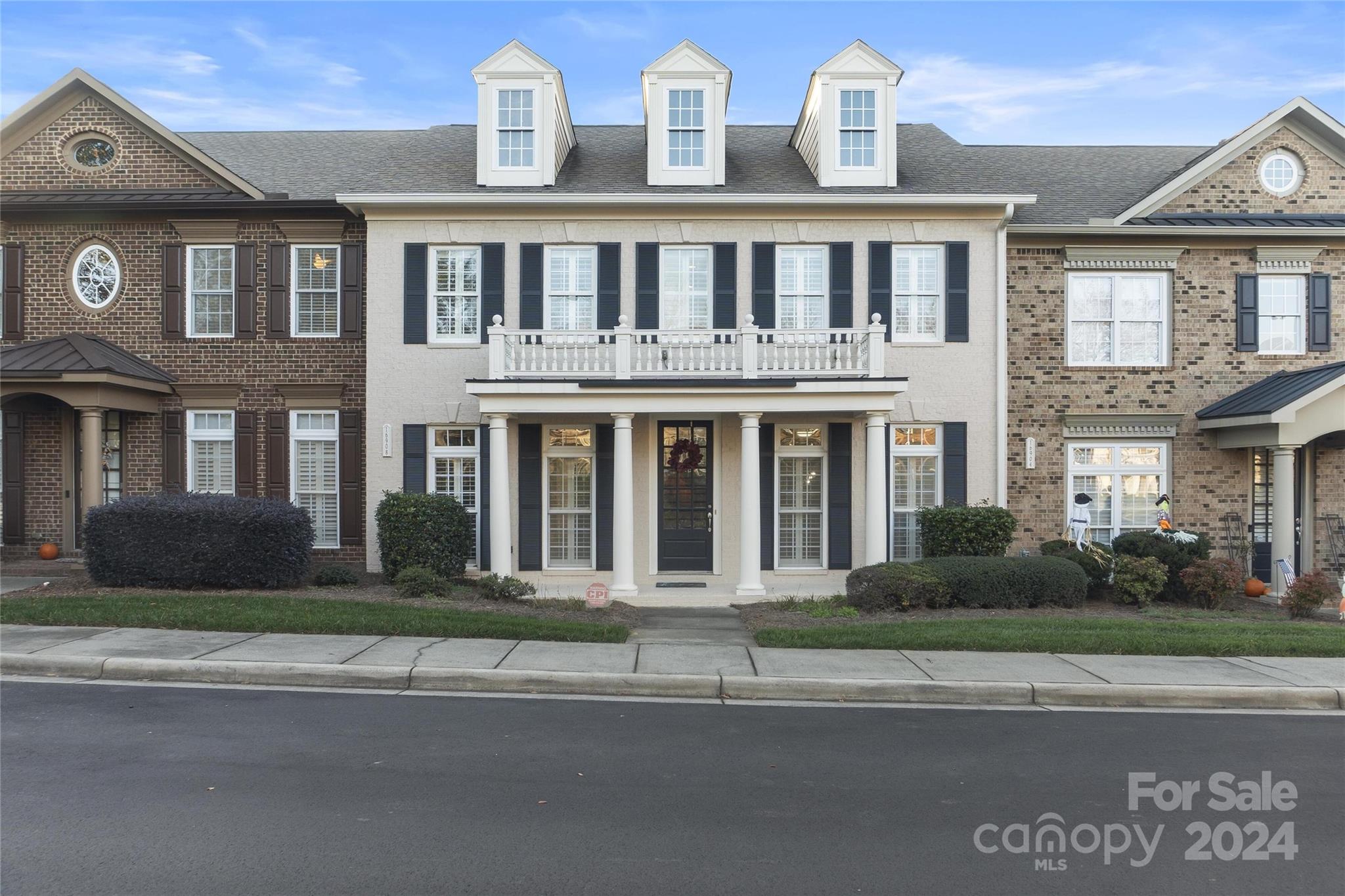 a front view of a residential apartment building with a yard