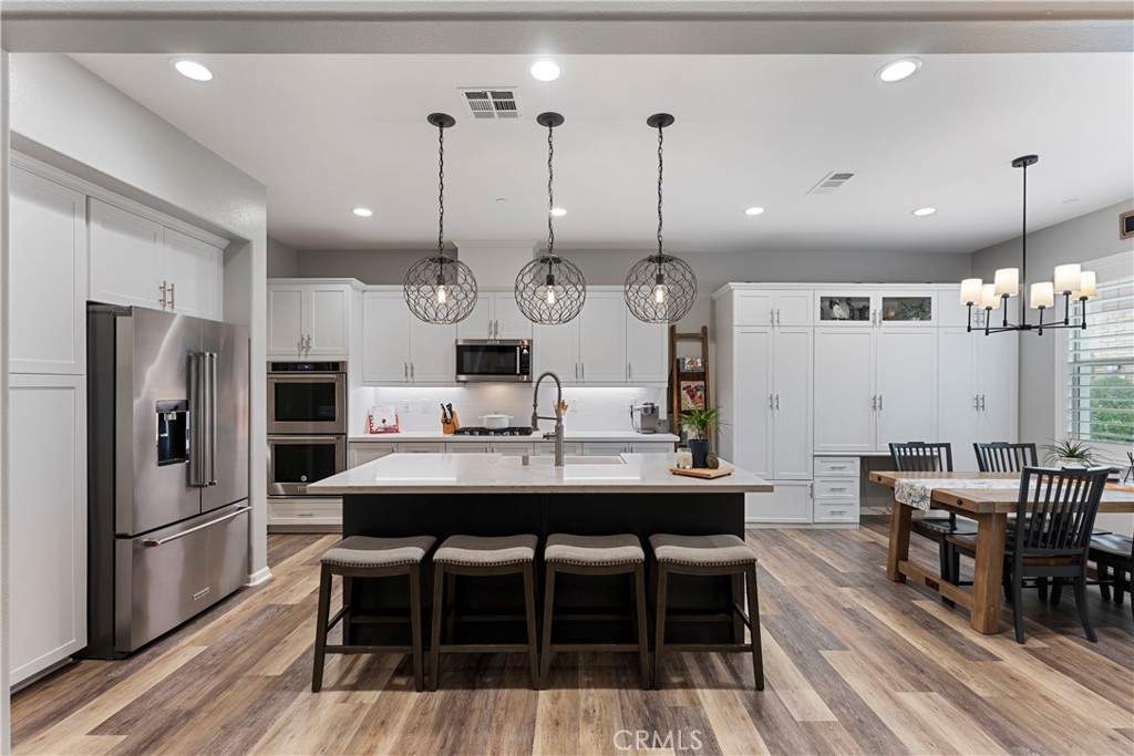 a large kitchen with a table and chairs