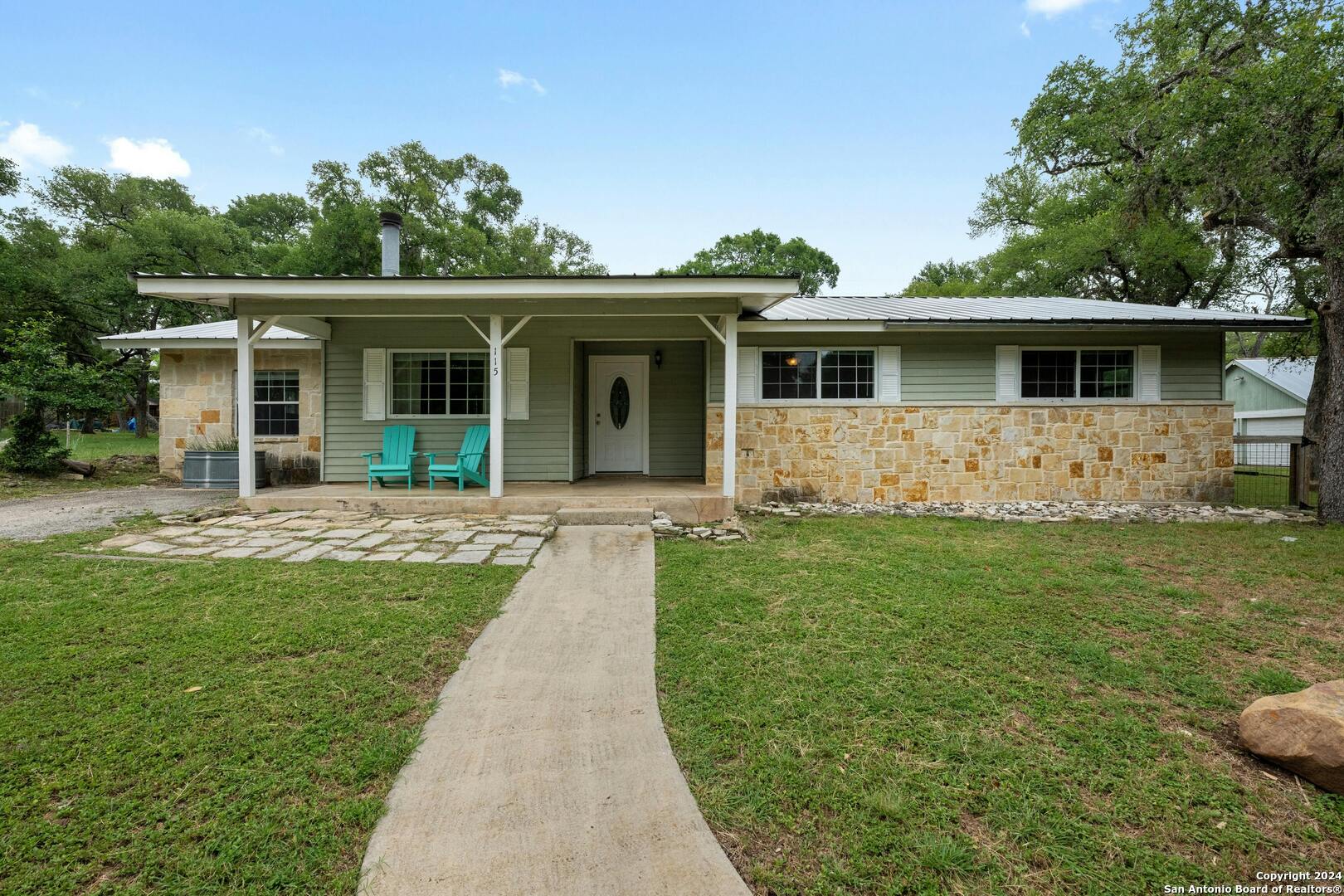 a front view of house with yard and green space