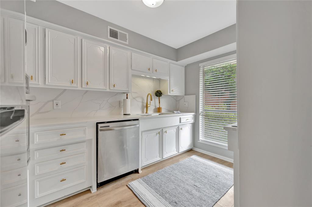 a kitchen with granite countertop white cabinets and white appliances