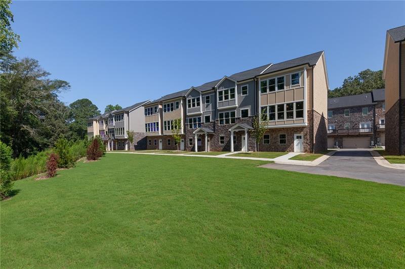 a view of house with yard and outdoor seating