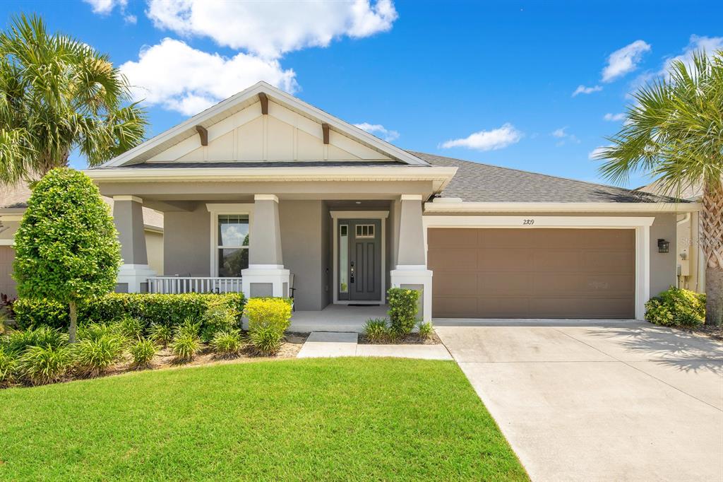 a front view of a house with a yard and garage