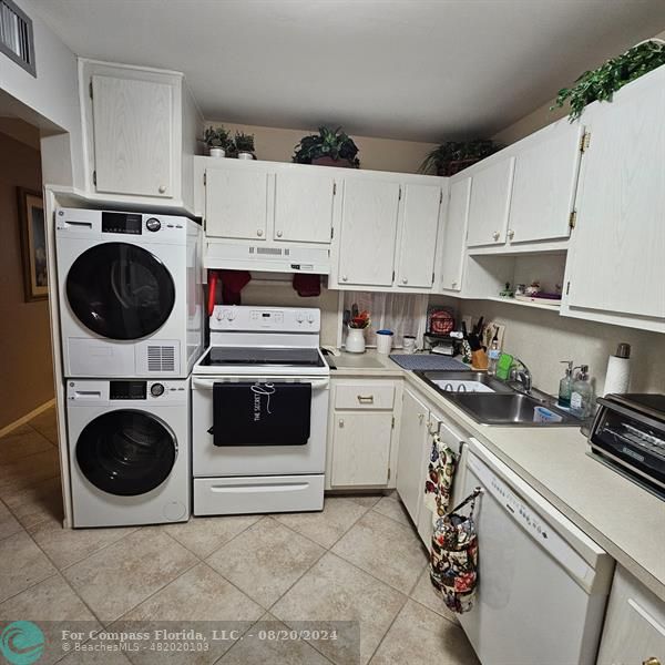 a kitchen with cabinets and white appliances