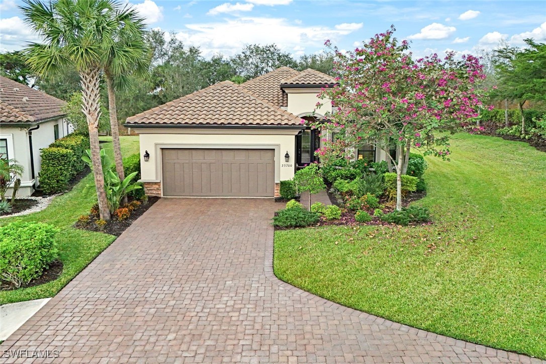 a front view of a house with a garden and yard