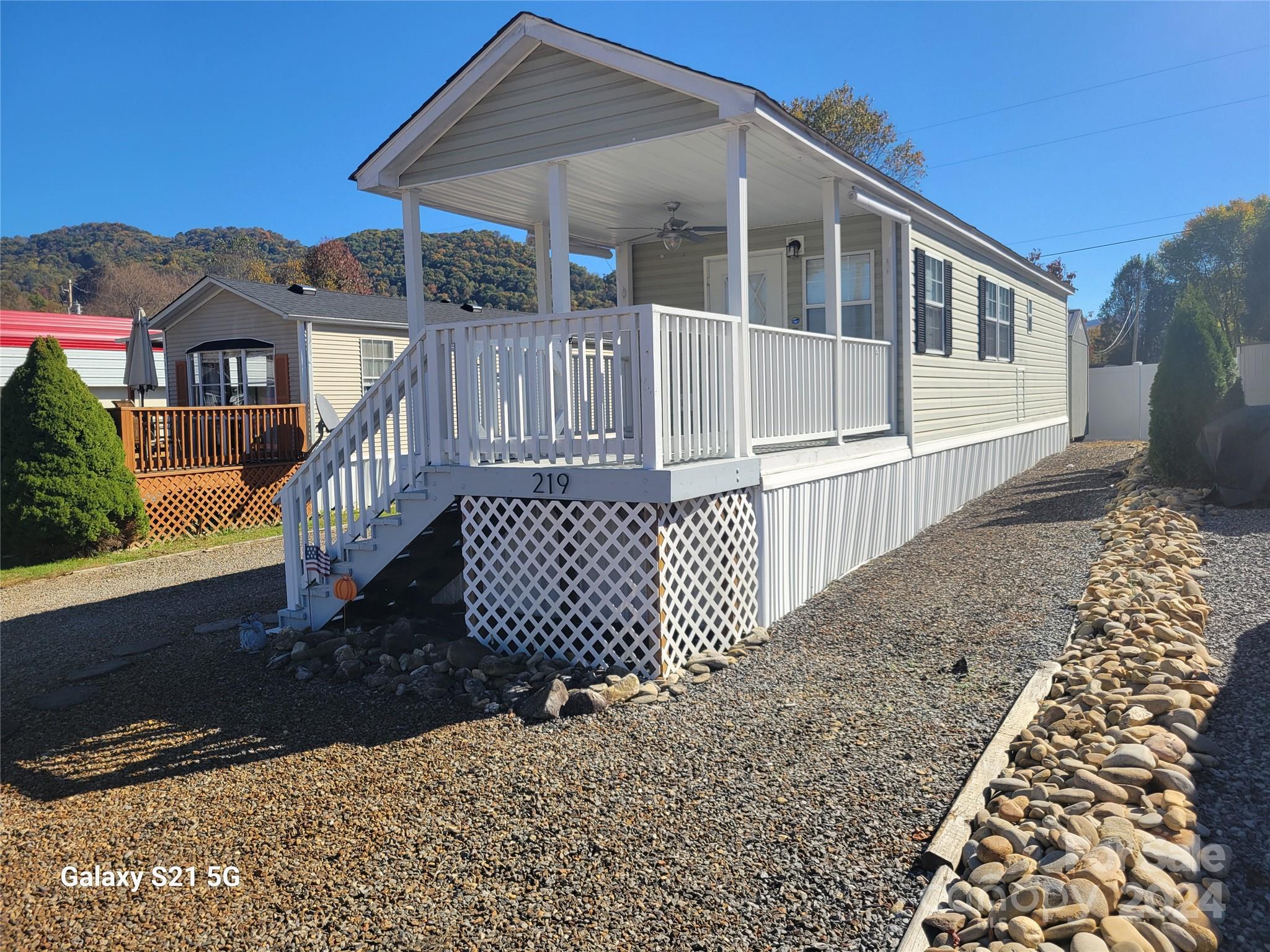 a view of a house with a wooden deck