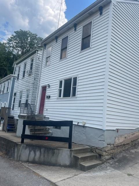 a view of a house with a small deck