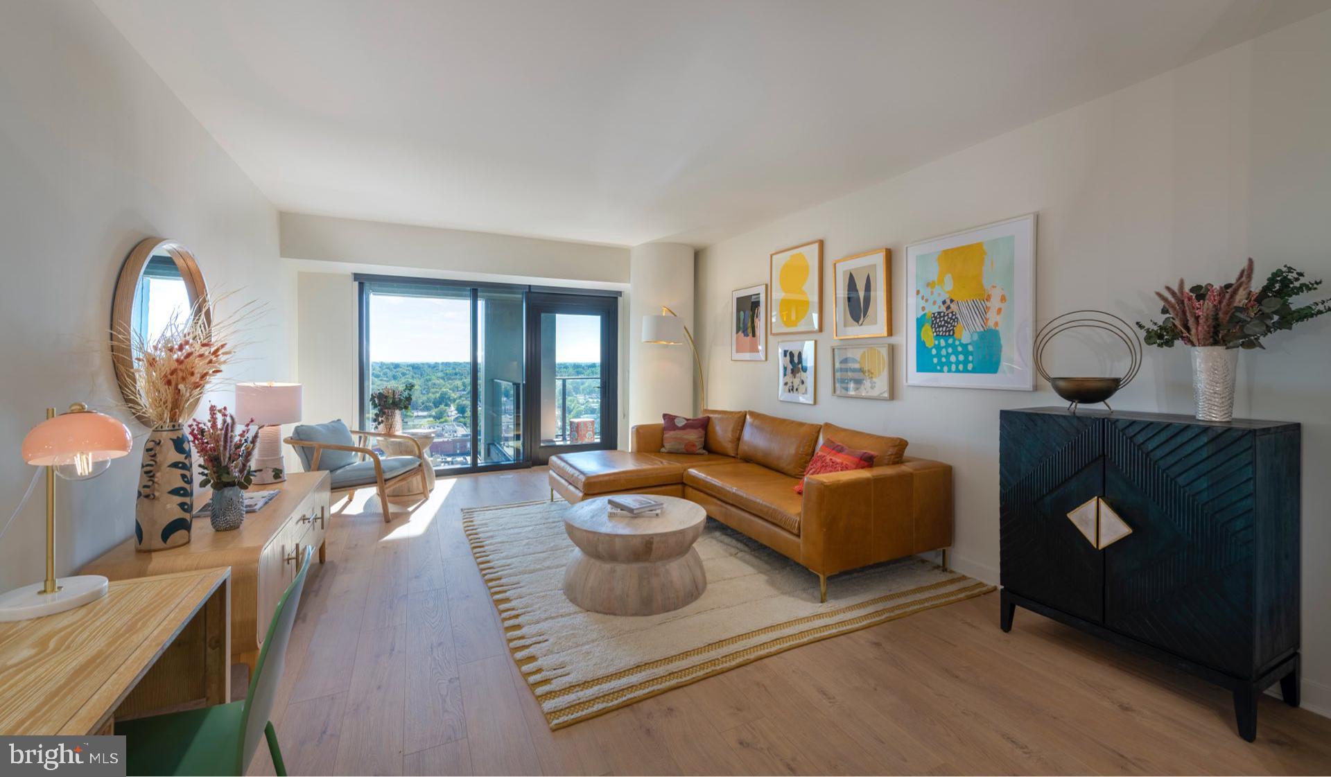 a living room with furniture fireplace and a large window