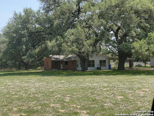 a house that has a tree in front of a house